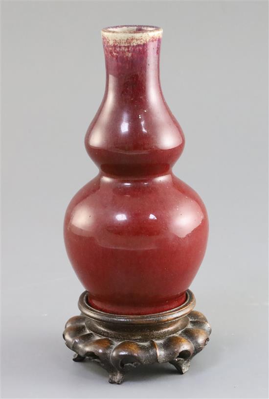 A Chinese Langyao sang de boeuf double gourd vase, Kangxi period, H. 15.5cm, wood stand